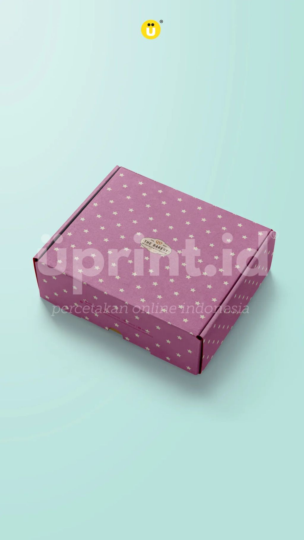 Kotak kue berwarna pink dengan motif bintang kecil dan logo The Bakery, ideal untuk kemasan kue.
