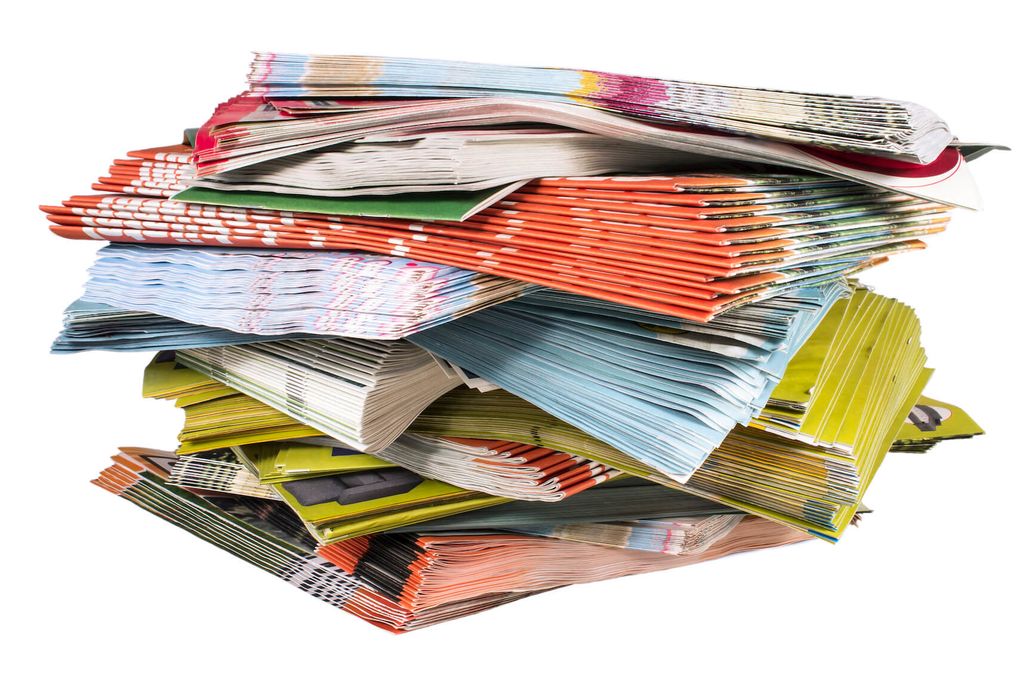 Pile of colorful printed materials on white background