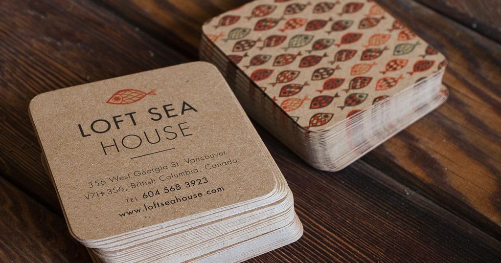 Kartu nama 'Loft Sea House' dengan desain unik dan latar belakang motif ikan.