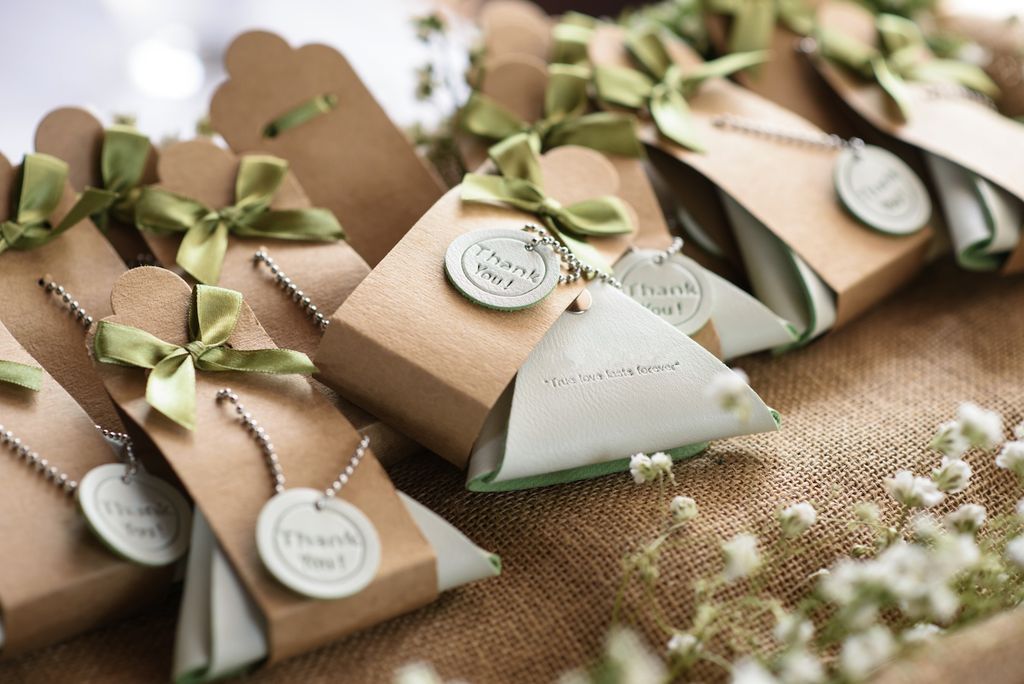 Rangkaian hadiah bridesmaid dalam kotak kraft dengan label terima kasih dan bunga putih untuk inspirasi kemasan hadiah pernikahan.