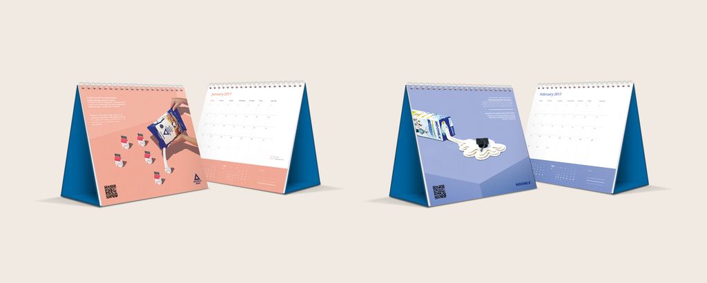 Dua kalender meja dengan desain unik dan promosi Indomilk, ideal untuk promosi bisnis.