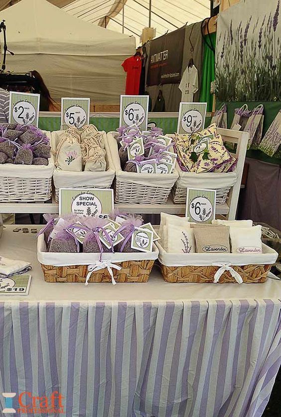 Stall display featuring lavender products in baskets and bags with price tags.