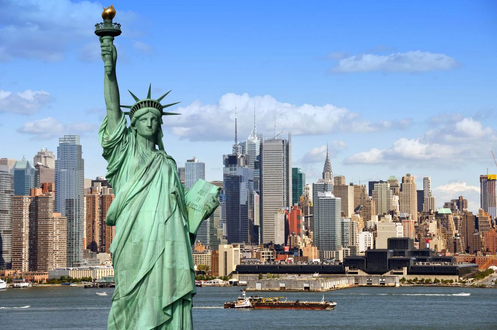Statue of Liberty standing tall against the backdrop of New York City's iconic skyline.