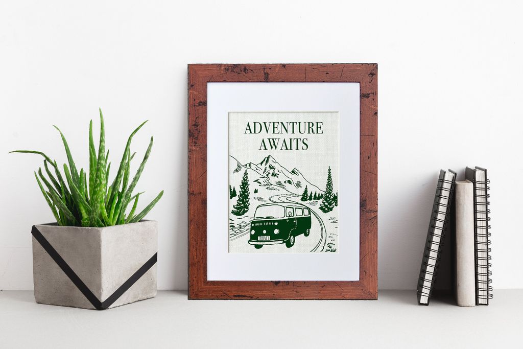Gambar frame dengan poster bertuliskan 'Adventure Awaits' dan gambar mobil di alam.