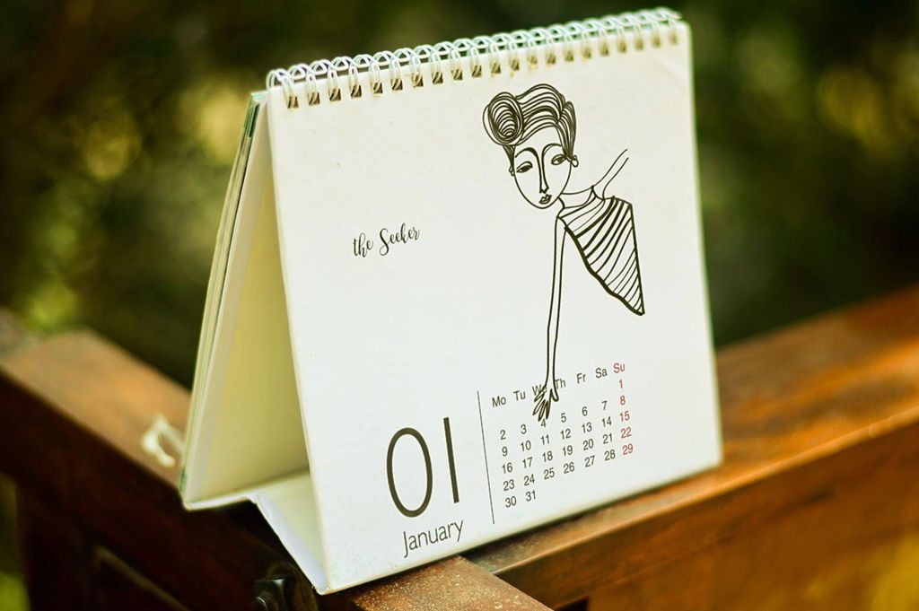 Kalender meja dengan desain minimalis dan gambar wanita modern, tanggal 1 Januari.
