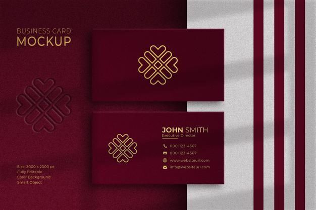 Desain kartu nama elegan dengan pola geometris emas dan latar belakang merah marun.