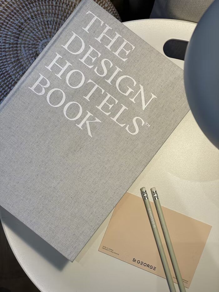Buku 'The Design Hotels Book' dan catatan di meja