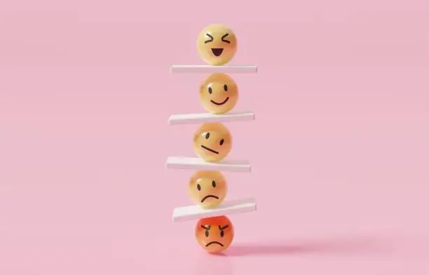 Emoticons arranged in a stack on shelves against a pink background.
