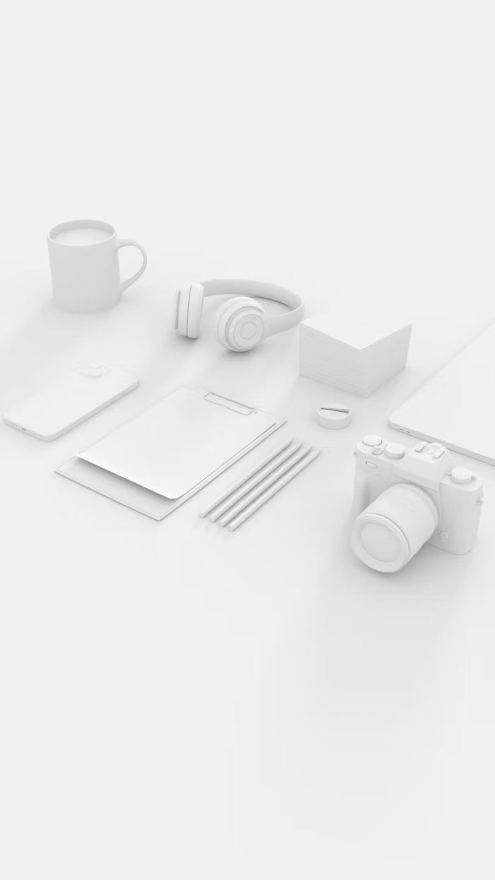 Assorted office items in white on a minimalist desk setup.