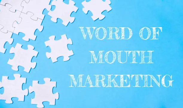 Puzzle bertema Word of Mouth Marketing sebagai ilustrasi studi kasus hasil cetak yang memicu rekomendasi organik