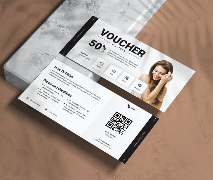 Desain voucher diskon 50% dengan informasi klaim dan kondisi.