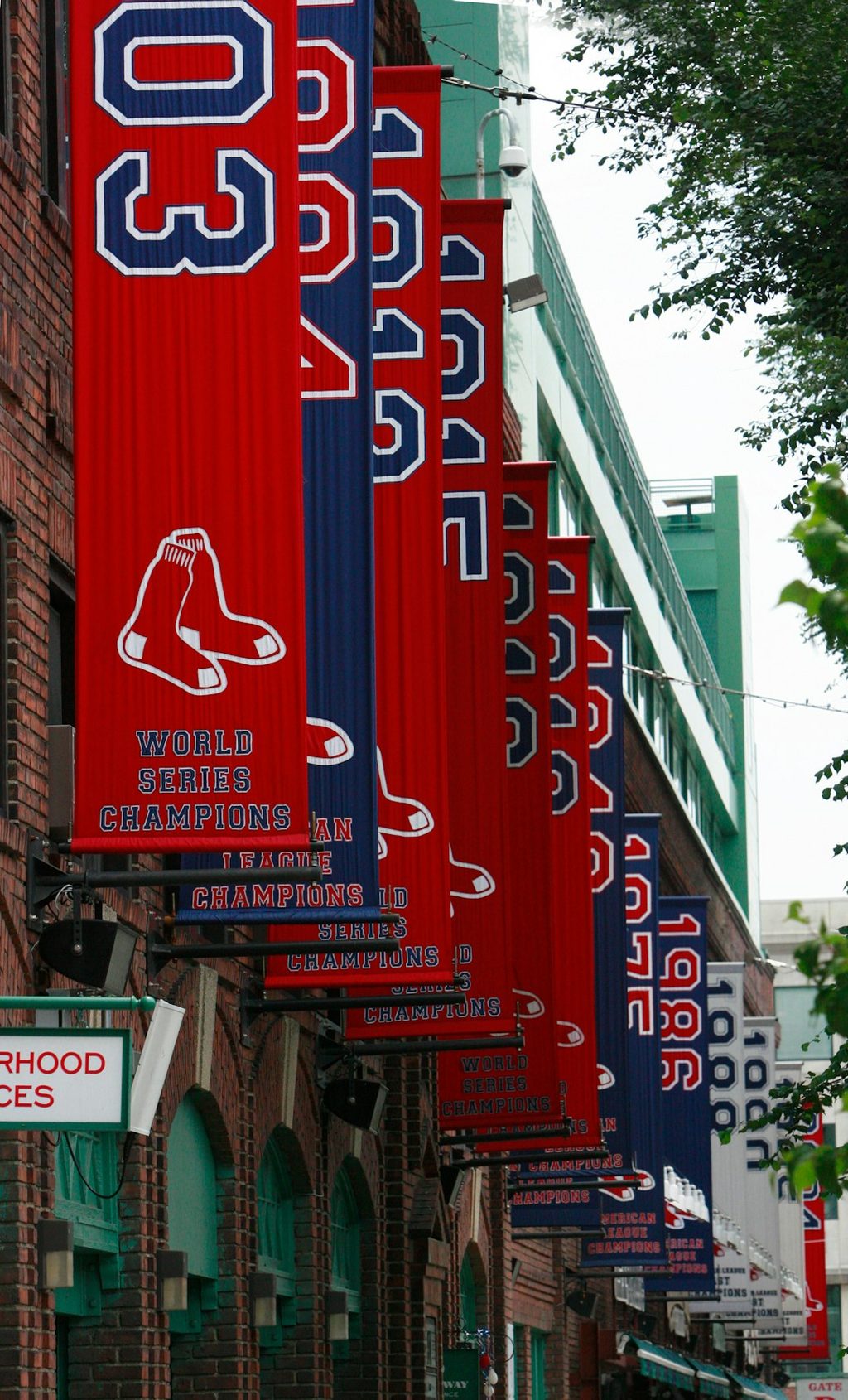 Red and blue banners celebrating World Series championships hanging on a building.