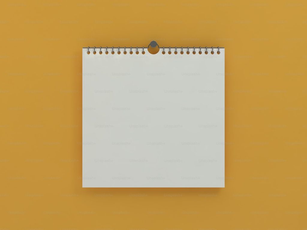 Kalender gantung putih minimalis untuk promosi brand dengan tampilan bersih dan premium
