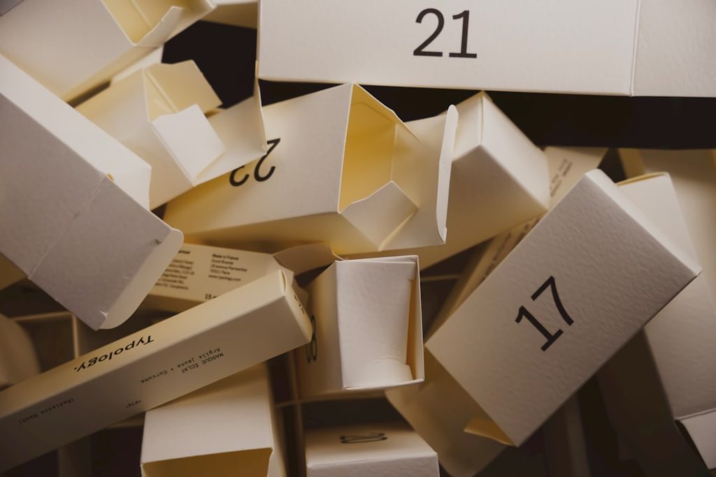 Stack of white boxes with numbers, representing packaging or marketing materials.