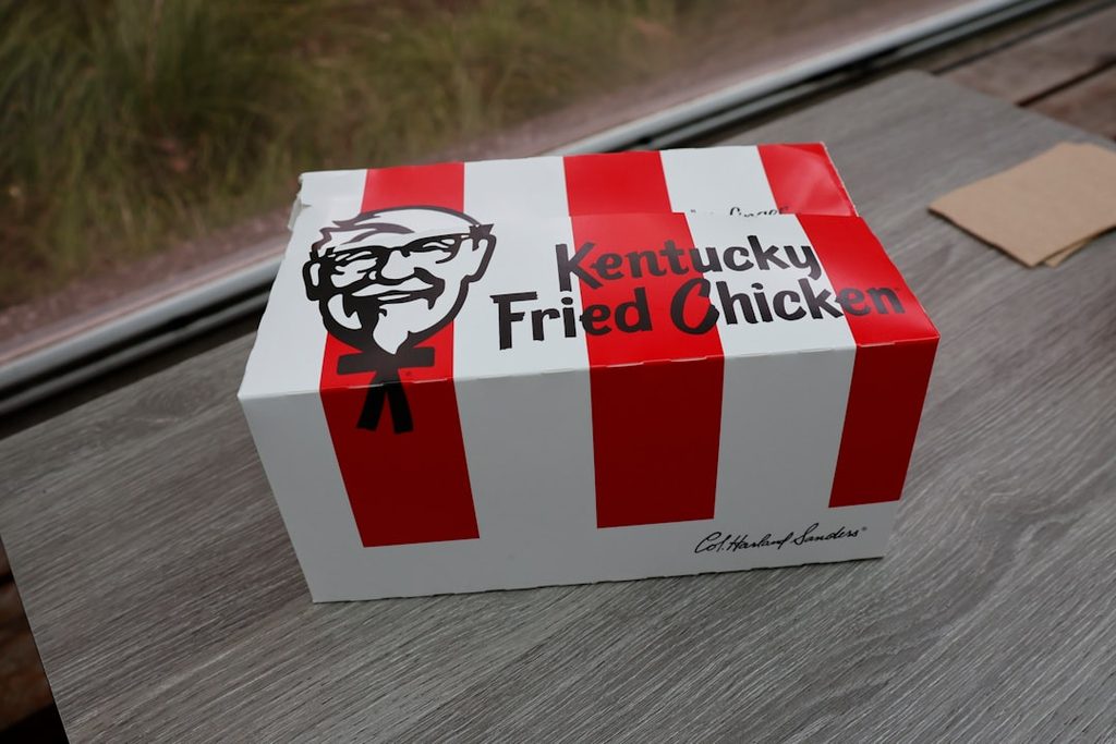 Kotak makanan Kentucky Fried Chicken dengan desain garis merah putih