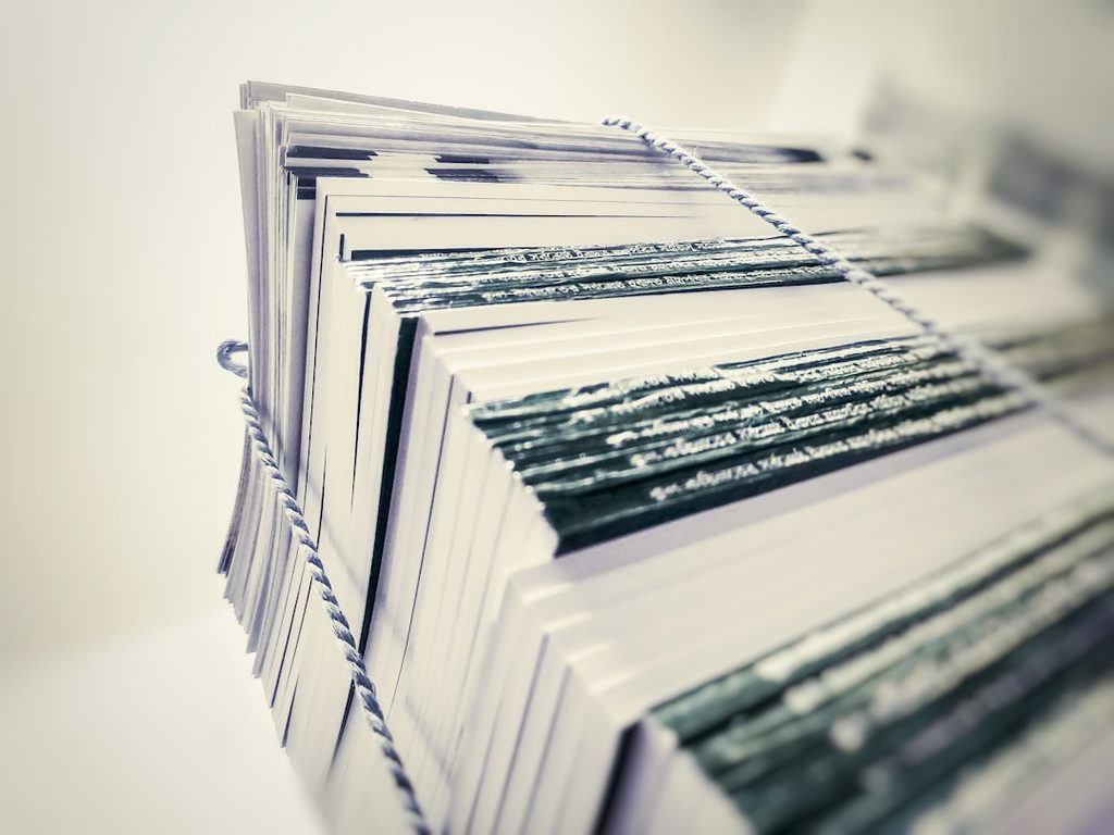Stack of printed papers with visible text and lines.