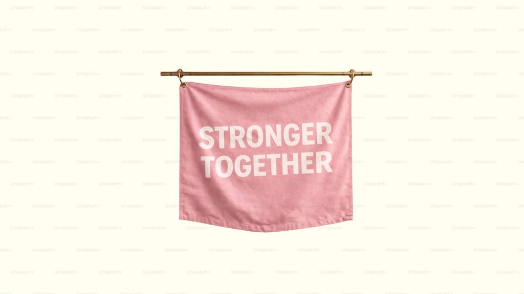 Banner merah muda dengan tulisan 'Stronger Together' di tengah.