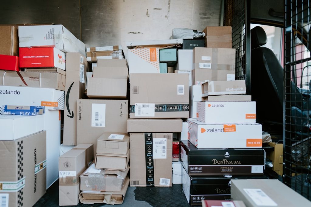 Stacked Amazon boxes in a warehouse setting.