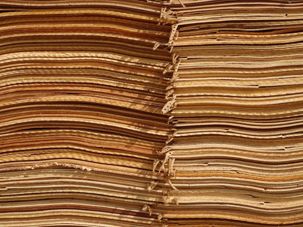 Close-up of neatly stacked folded paper sheets, ideal for printing and packaging materials.