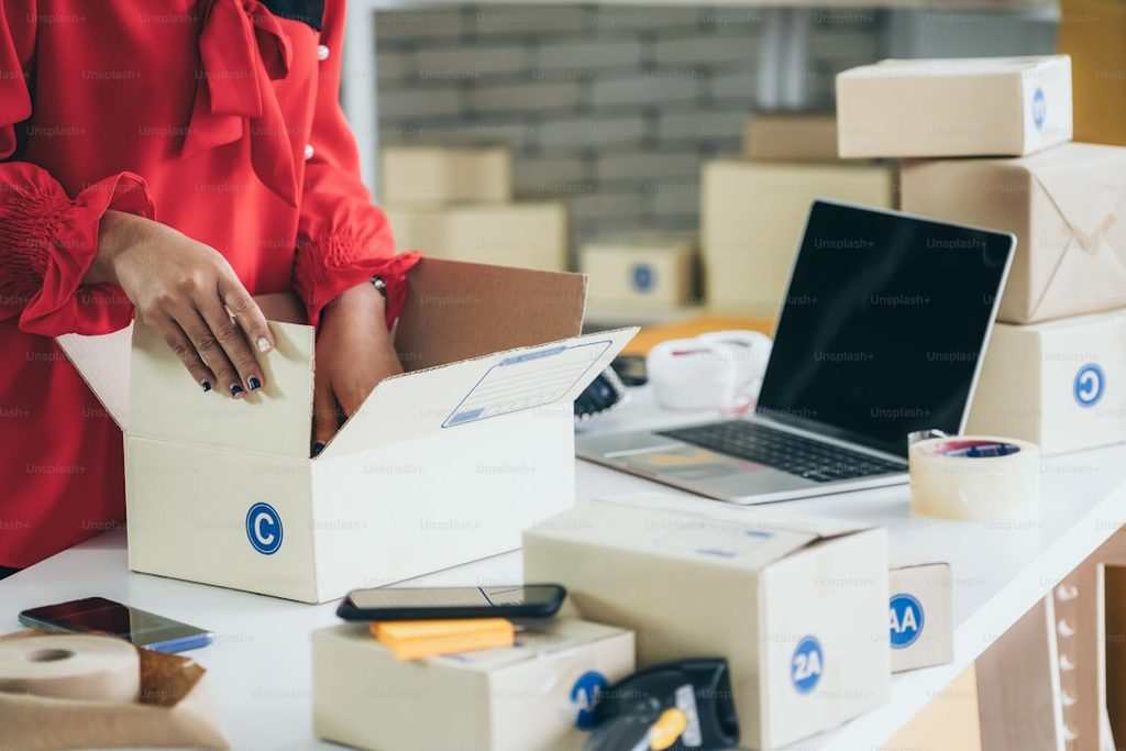 Packing and preparing online orders for shipping at a printing service.