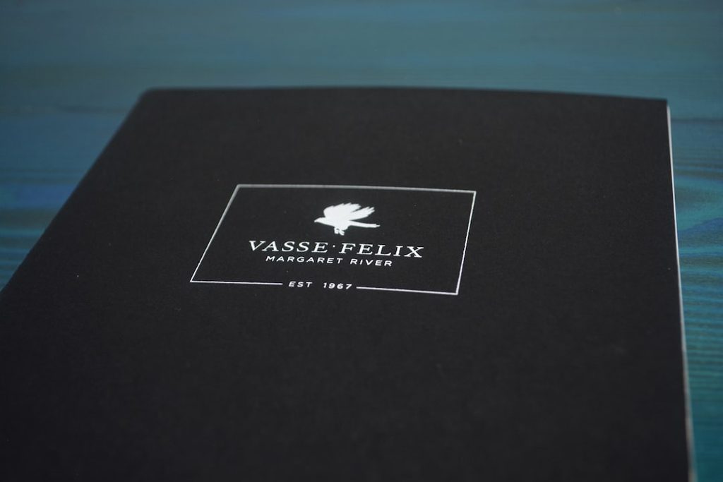 Brosur hitam dengan logo Vasse Felix dan tulisan 'Handcrafted Paper' di bagian tengah.