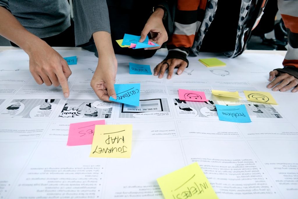 team collaborating with sticky notes discussing customer journey planning