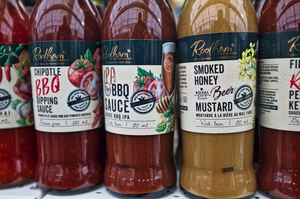 Beberapa botol kemasan makanan dengan label berwarna dan desain menarik.