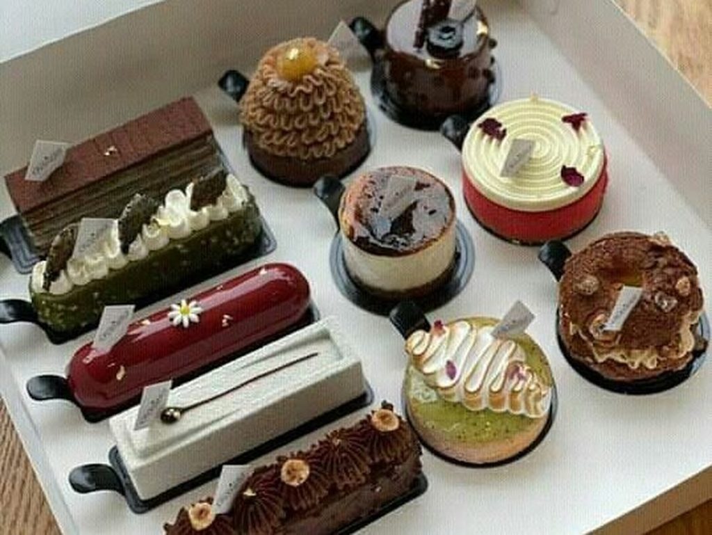 Koleksi aneka kue dan makanan kekinian dalam kotak yang rapi untuk acara spesial.