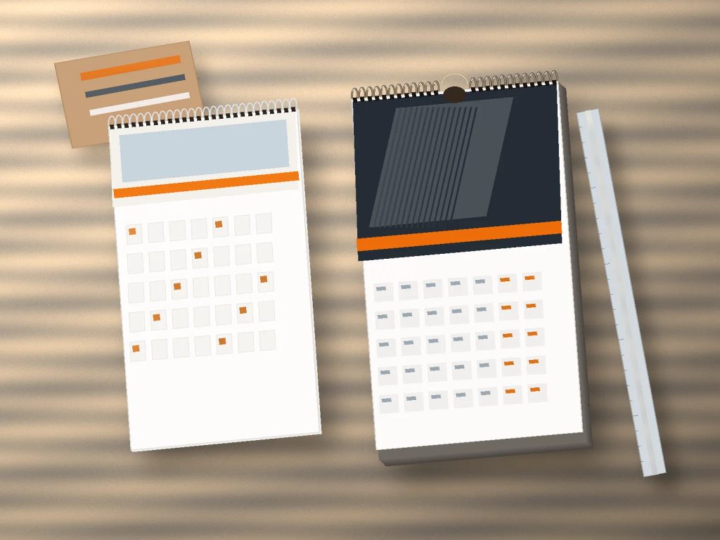 Perbandingan kalender dinding spiral atas varian standar UMKM dan korporat di meja percetakan.
