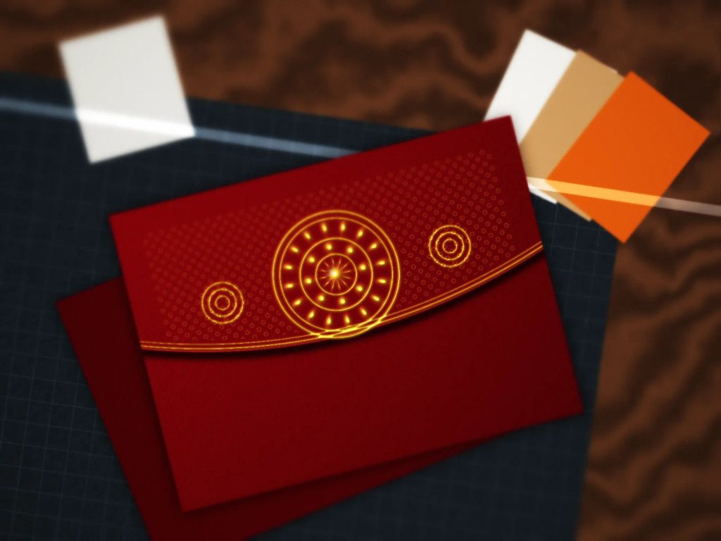 Detail tekstur kertas mewah dan finishing foil emas amplop angpao Imlek custom di meja percetakan.