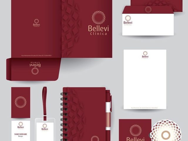 Rangkaian desain branding klinik Bellevi dalam warna merah burgundy, termasuk brosur, kartu nama, dan stiker.