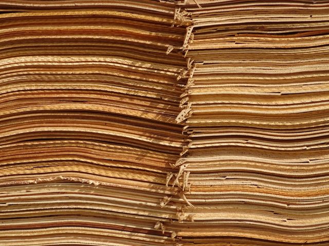 Close-up of neatly stacked folded paper sheets, ideal for printing and packaging materials.